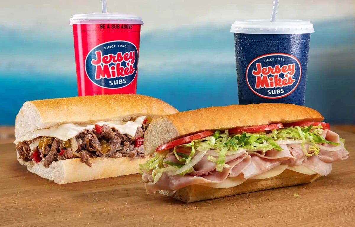 A Jersey Mike's cheesesteak and classic cold sub with branded drink cups